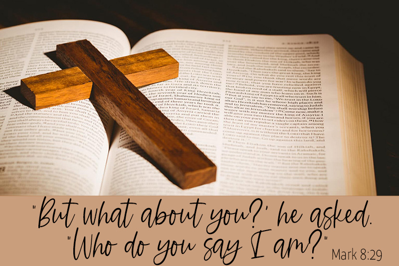 Picture of the Bible with a wooden Cross on it.
